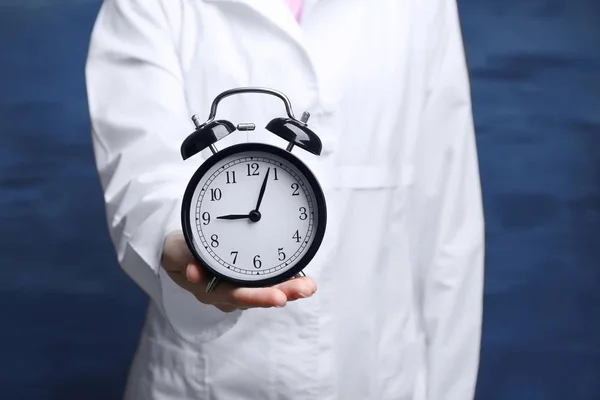 Doctor holding alarm clock — Stock Photo, Image