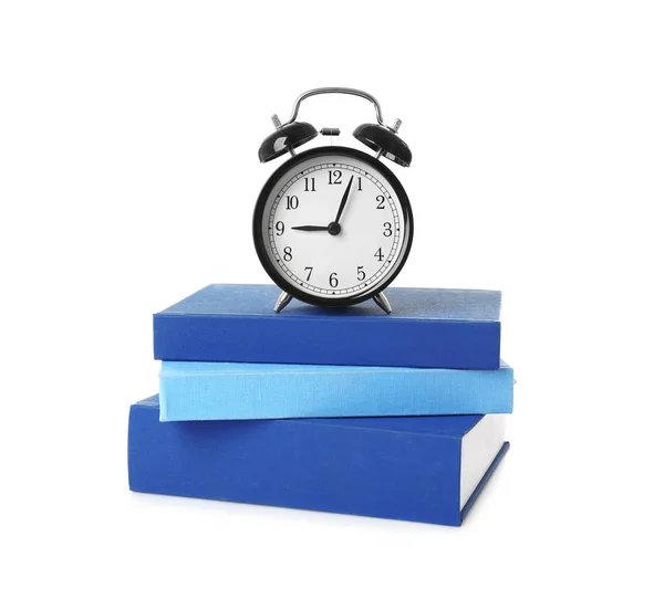 Alarm clock and stack of books — Stock Photo, Image