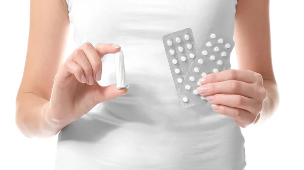 Woman holding tampon and pills — Stock Photo, Image