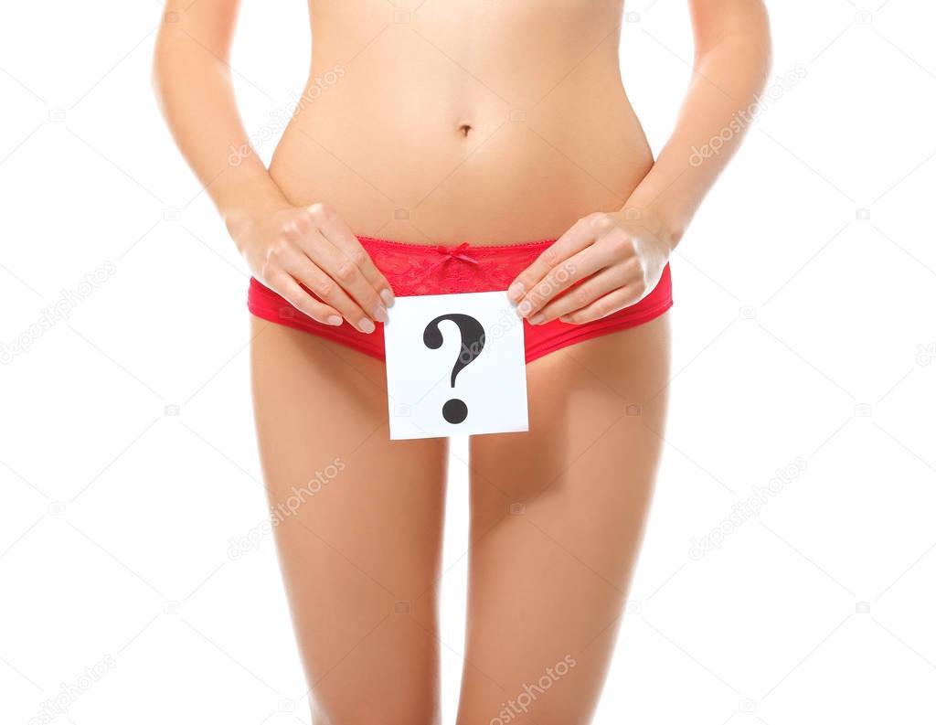 Close up view of young woman holding paper sheet with question mark, on white background. Gynecology concept