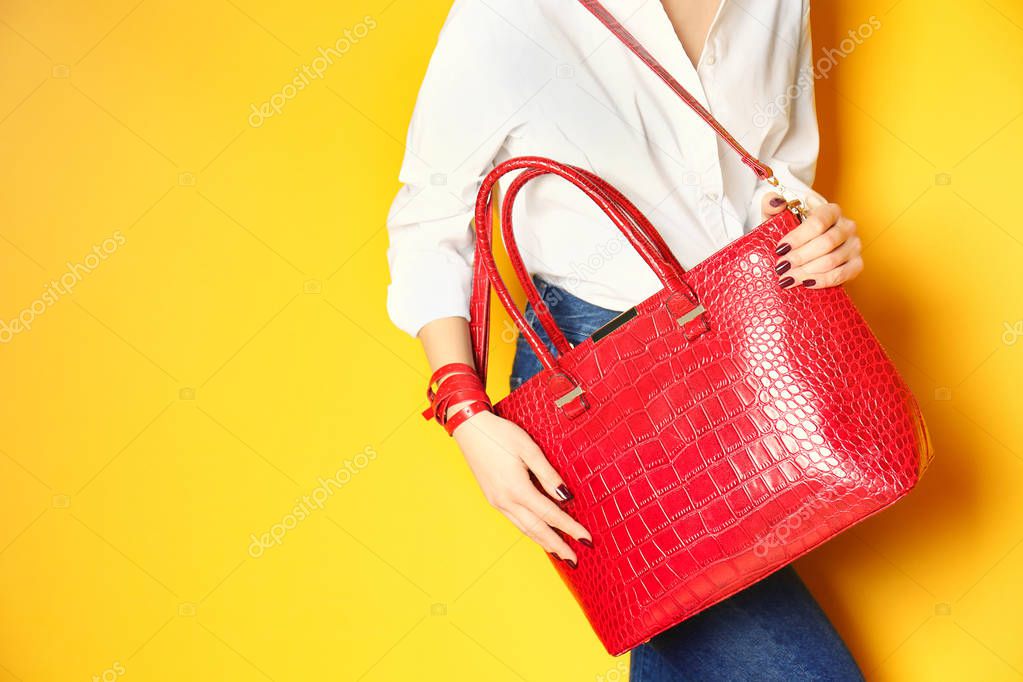 woman holding red handbag 