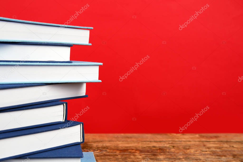 Pile of books on wooden table 