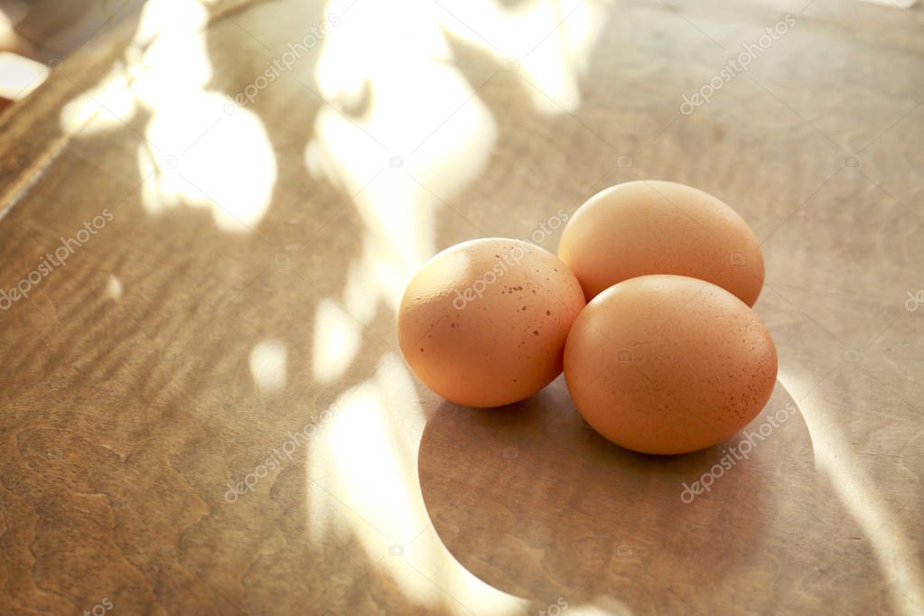 Raw eggs on wooden table