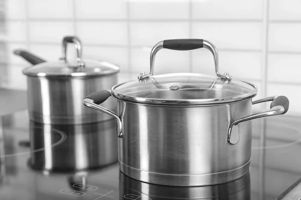 Metal saucepan on stove — Stock Photo, Image