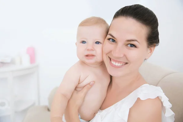 Mother holding little baby indoors — Stock Photo, Image