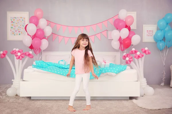 Girl in room decorated for celebration — Stock Photo, Image