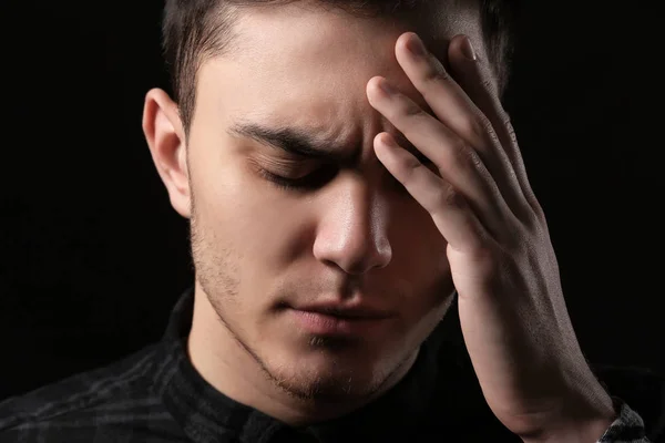 Handsome depressed man on black background — Stock Photo, Image