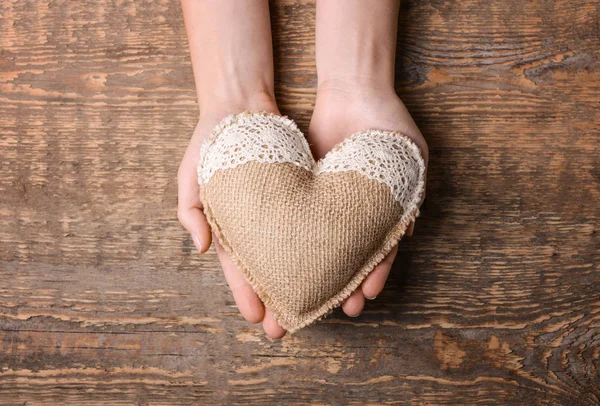 Hands holding handmade heart — Stock Photo, Image