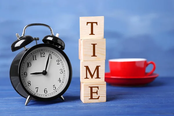 Cubes with alarm clock and cup — Stock Photo, Image