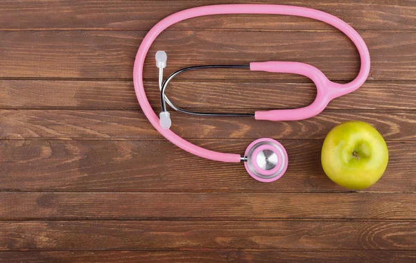 Rosa stetoskop med apple — Stockfoto