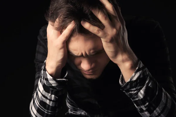 Handsome depressed man on black background — Stock Photo, Image