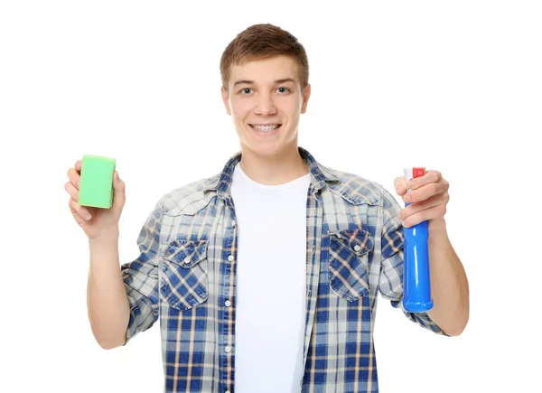 Joven hombre de servicio con aerosol de limpieza y esponja sobre fondo blanco —  Fotos de Stock