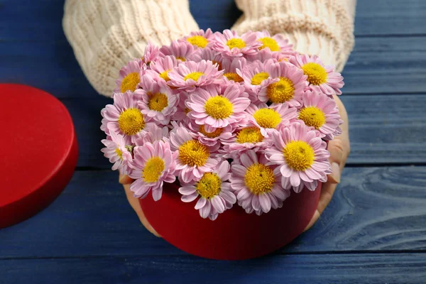 Woman holding beautiful flowers in box — Stock Photo, Image