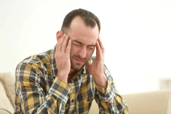 Handsome man suffering from headache — Stock Photo, Image