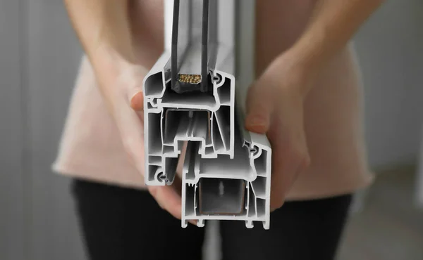 Woman holding sample of window profile — Stock Image Woman holding sample of window profile Stock Photo