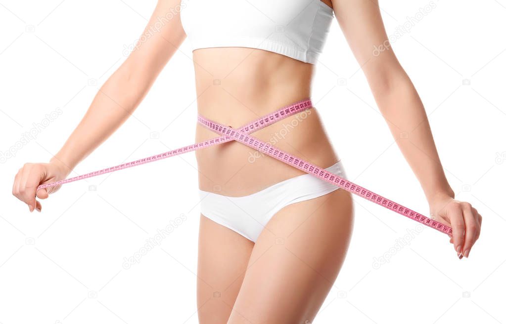 Beautiful young woman with measuring tape on white background