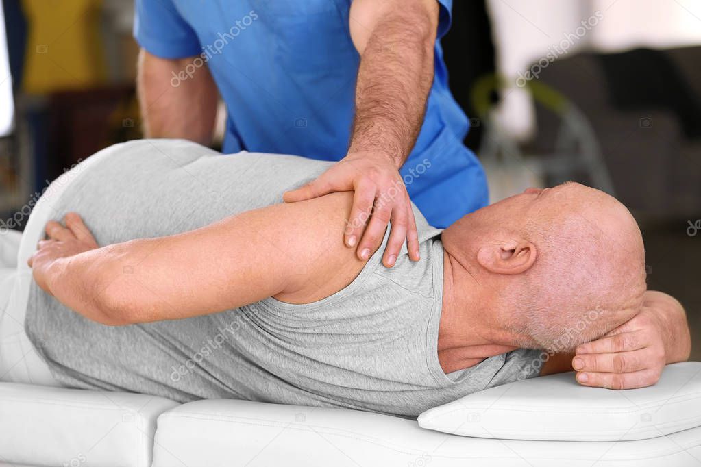 Physiotherapist working with patient
