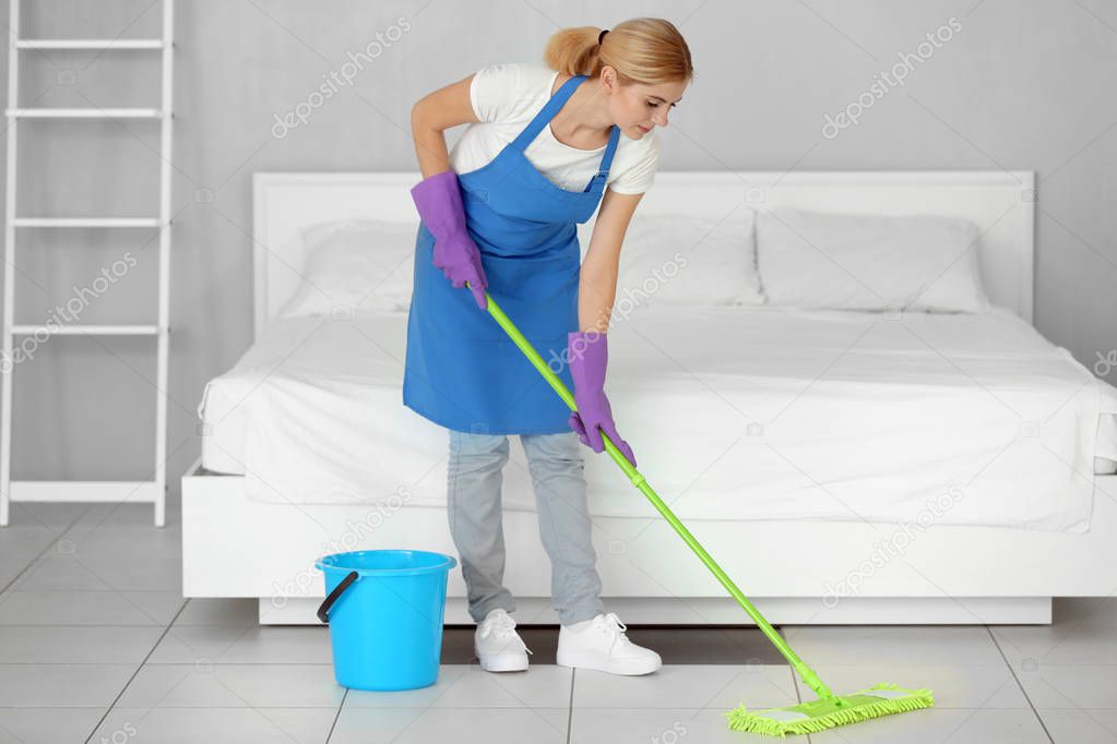 Pretty woman moping floor 