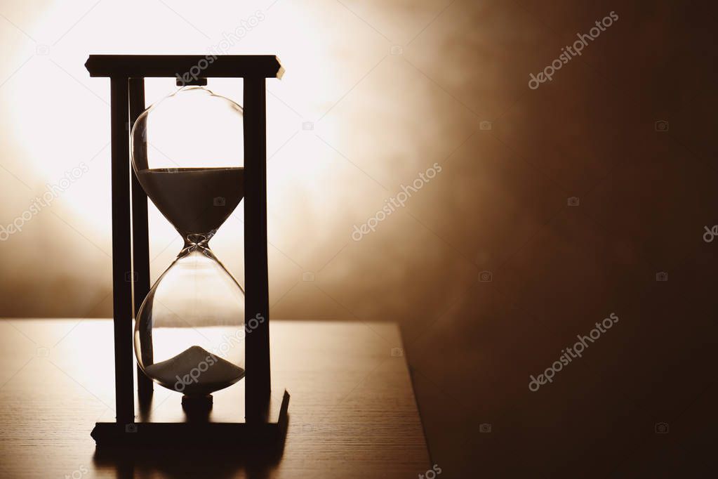 Silhouette of hourglass with sand 