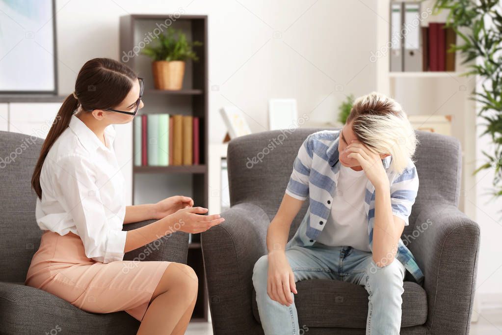 psychologist working with teenager boy