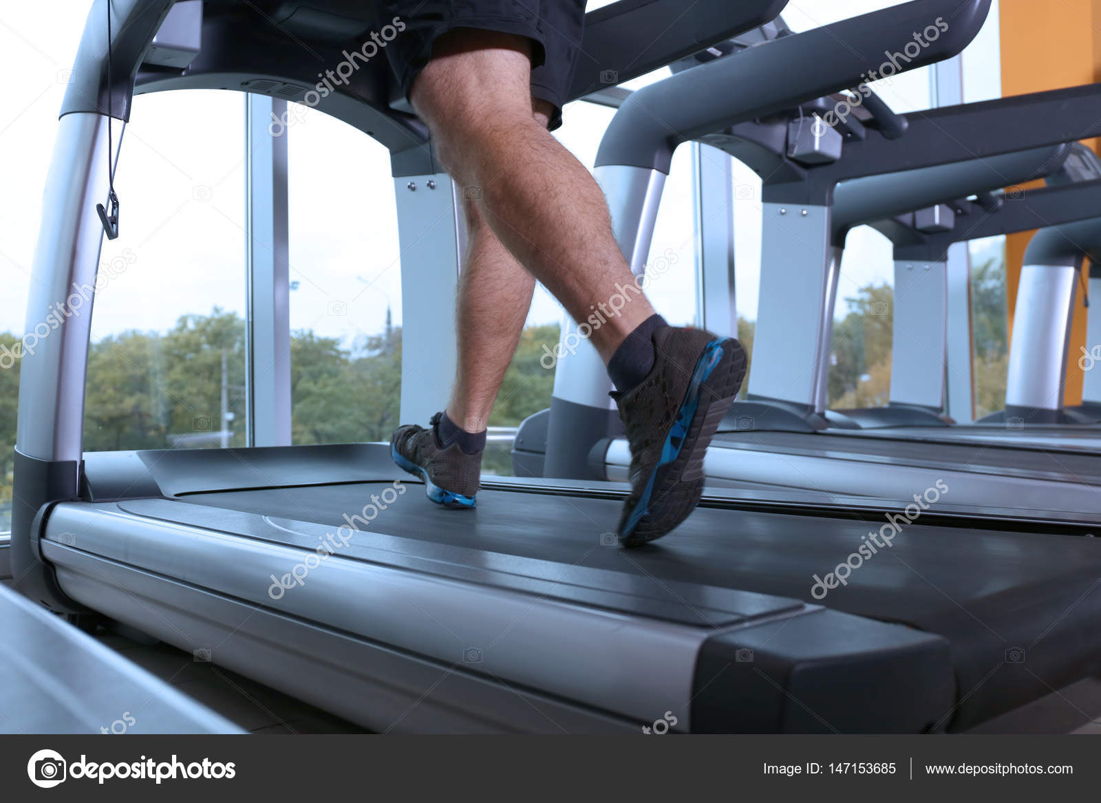 African American Man Running On Treadmill In Gym Stock Photo