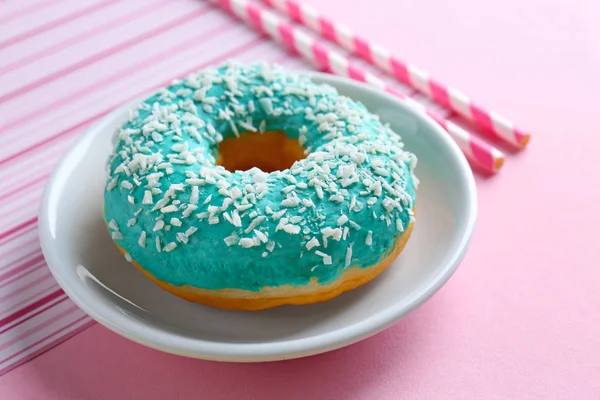 Tasty glazed donut with coconut flakes