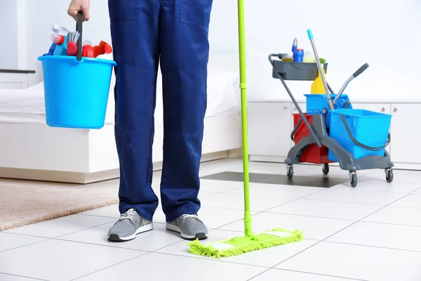 Legs of man with cleaning supplies — Stock Photo, Image