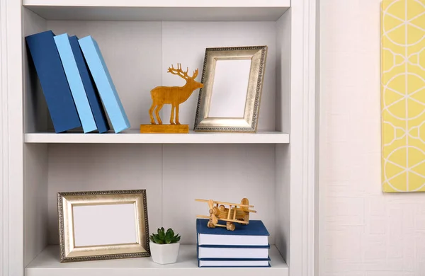 Shelving with books and decoration — Stock Photo, Image