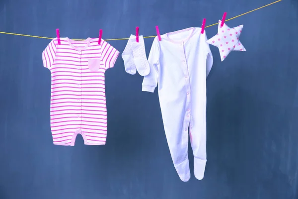 Clothesline with hanging baby clothes — Stock Photo, Image