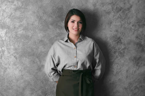 Young woman in brown apron — Stock Photo, Image