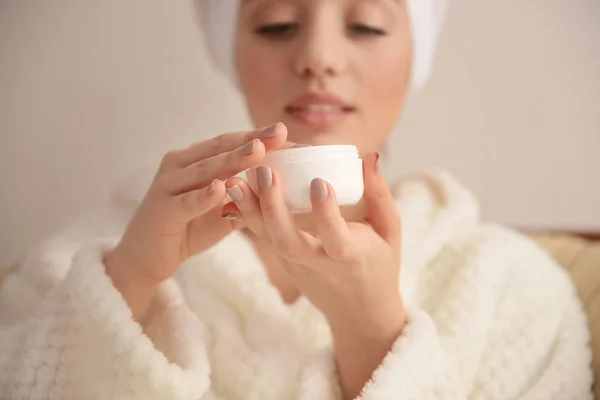 Beautiful young woman applying cream — Stock Photo, Image