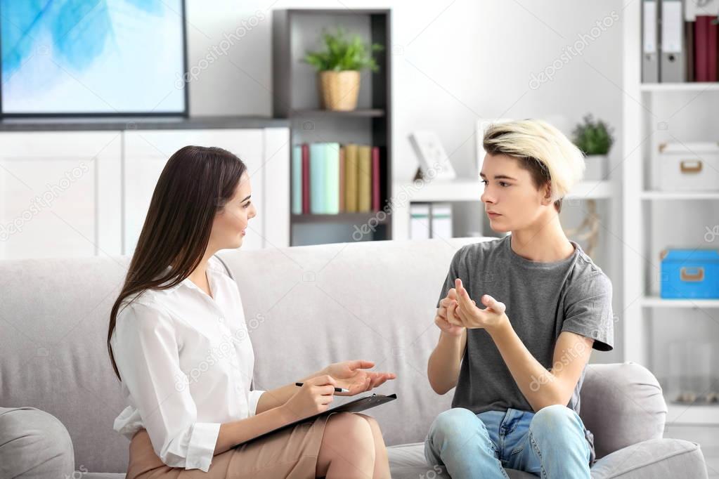 psychologist working with teenager boy