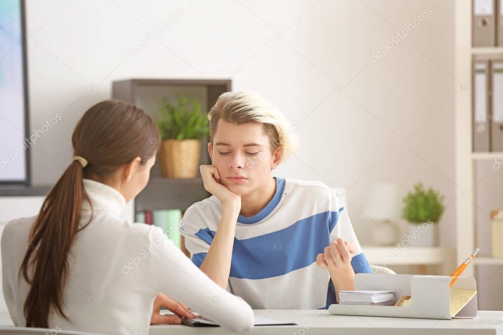 psychologist working with teenager boy