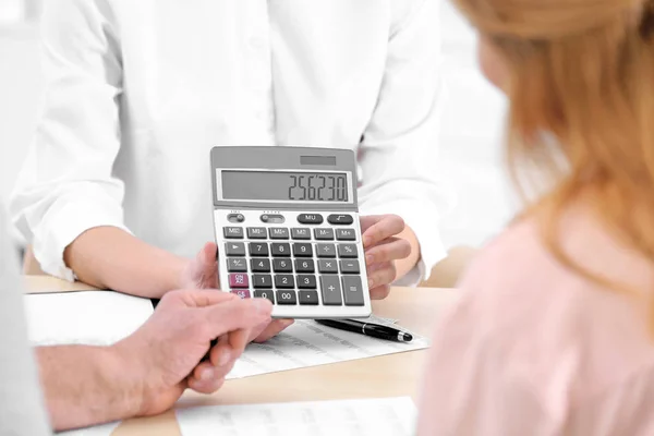 Insurance agent showing calculator