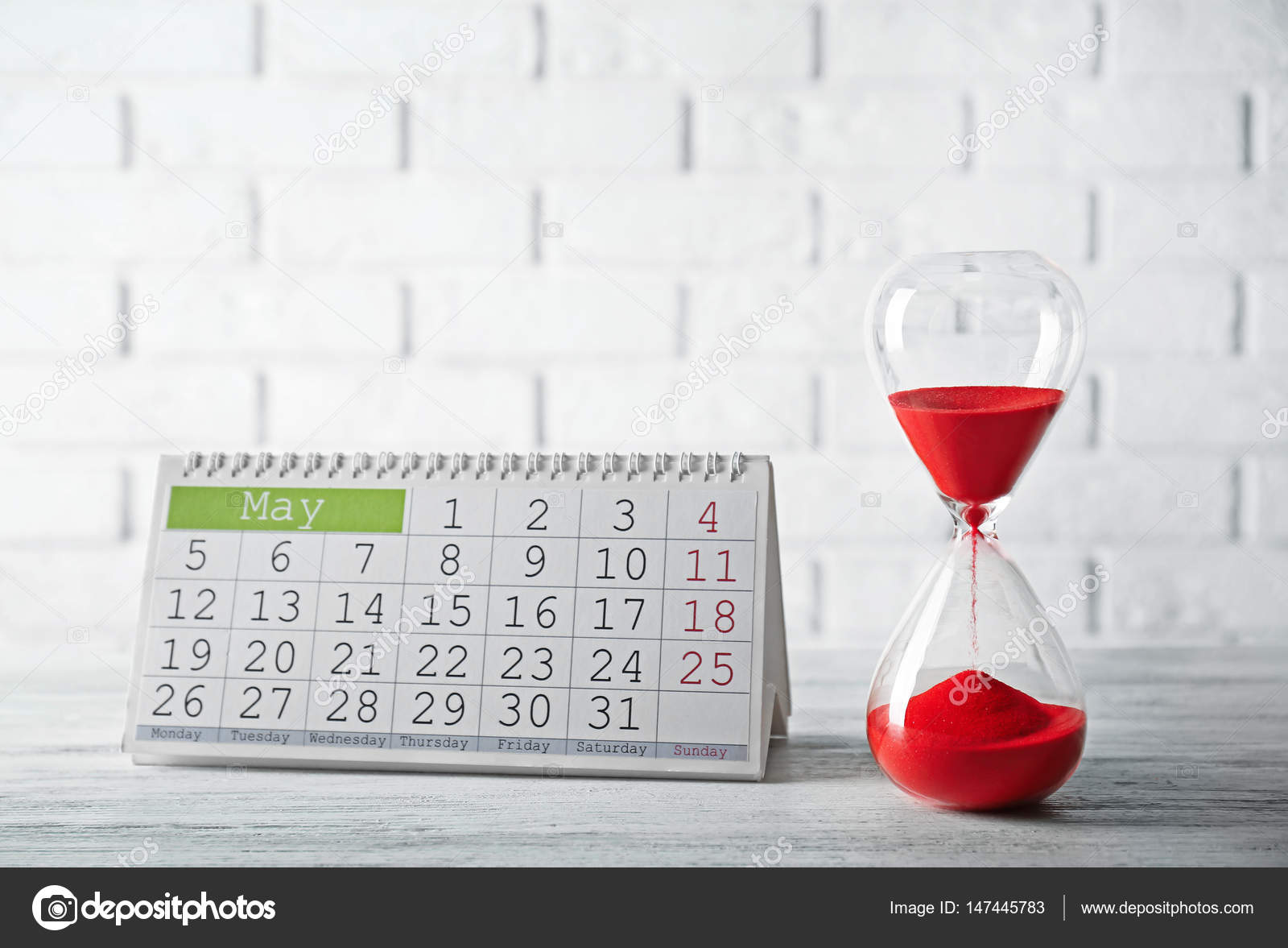 Hourglass with red sand and calendar — Stock Photo © belchonock 147445783