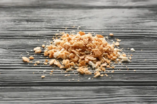 Bread crumbs on wooden table