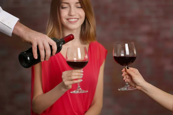 Waiter serving wine to woman — Stock Photo, Image