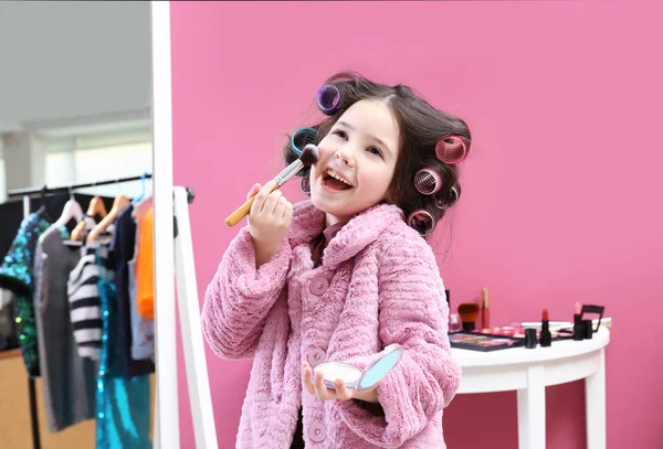 Cute little girl playing with her mother's cosmetic at home — Stock Photo, Image