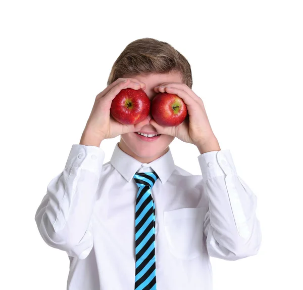 Écolier mignon avec des pommes sur fond blanc — Photo