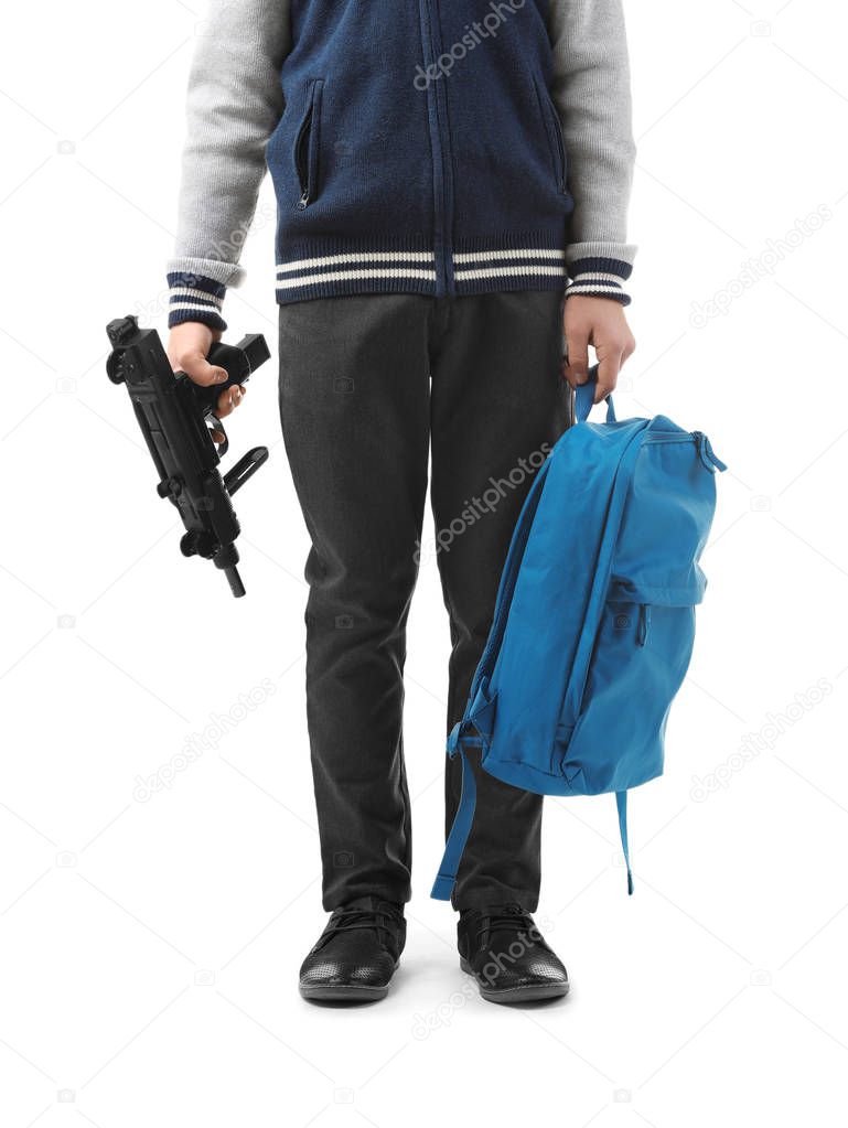 Teenage boy with backpack holding gun