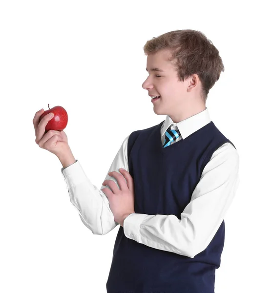 Милий школяр з яблуком на білому тлі — стокове фото
