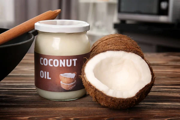 Glass jar with coconut oil and nuts — Stock Photo, Image