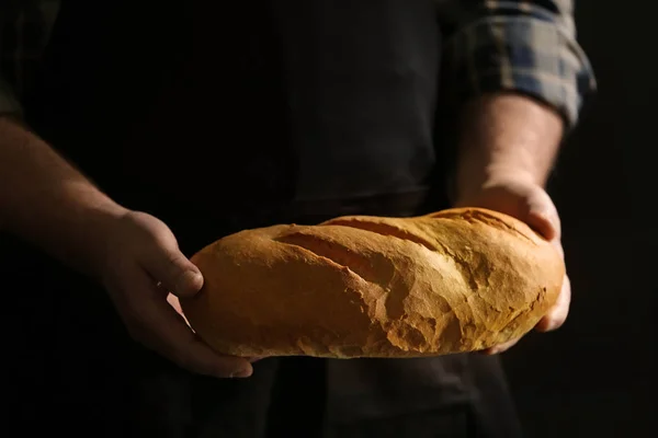 Male hands with loaf of bread — Stock Photo, Image