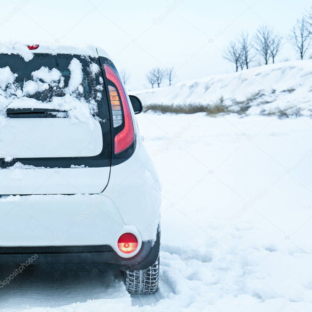 Car stuck in snowdrift on winter road