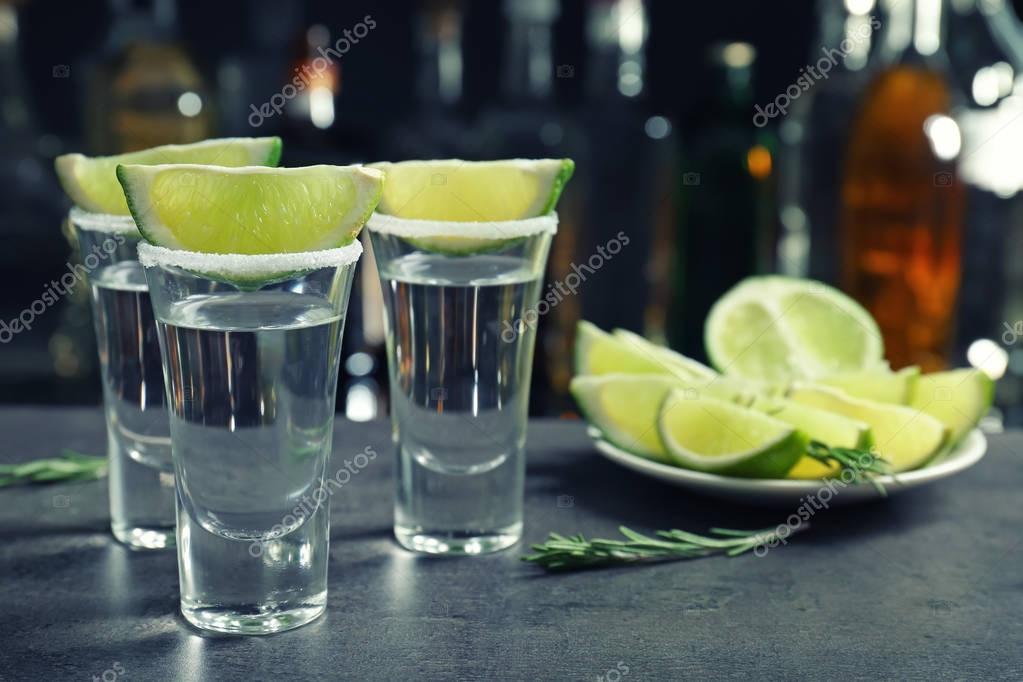 Tequila shots with juicy lime — Stock Photo © belchonock #147478963