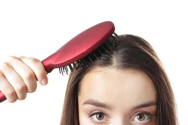 Mujer joven cepillando el cabello — Foto de Stock