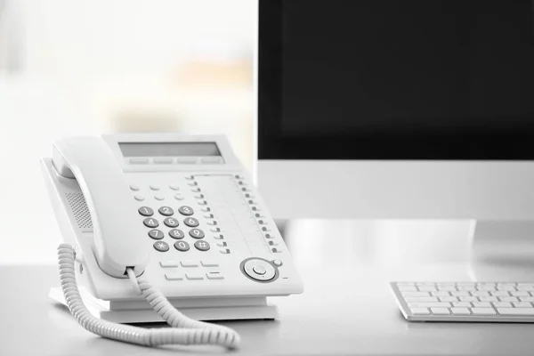 Telephone and computer on table — Stock Photo, Image
