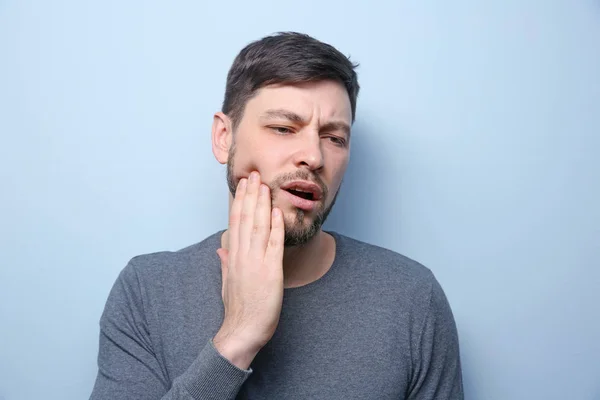 Handsome man suffering from toothache — Stock Photo, Image