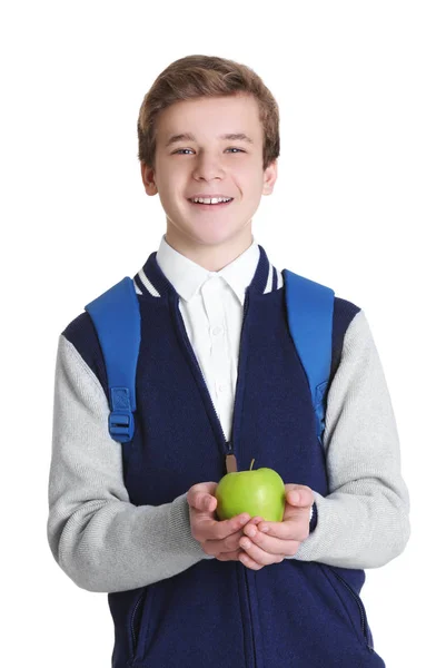Écolier mignon avec pomme sur fond blanc — Photo