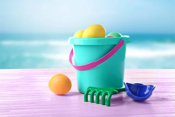 Easter eggs with toddler beach kit — Stock Photo, Image